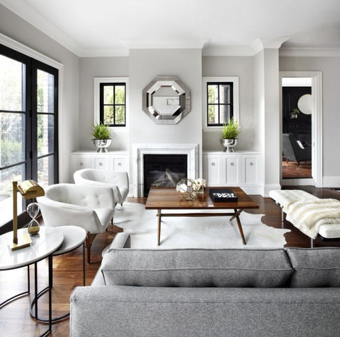 Luxe lounge room with a grey couch and a pair of white tub chairs