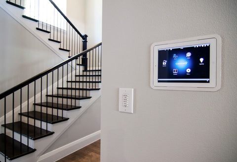 Tablet mounted on wall with staircase