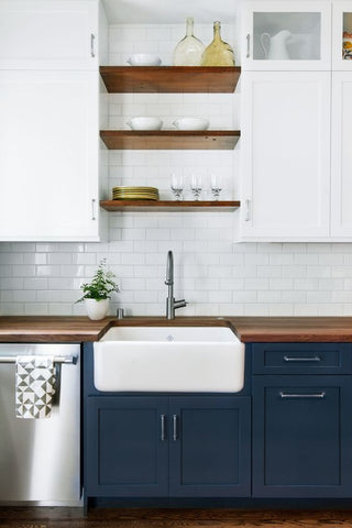 Kitchen sink with dark blue cabinets