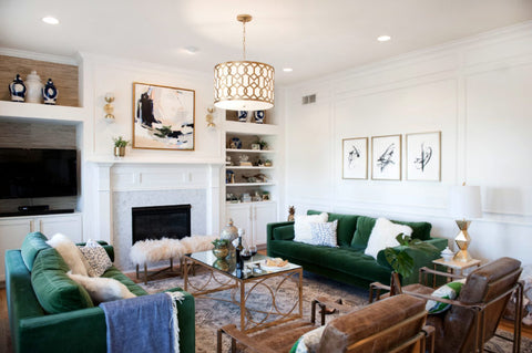 Living room interior with dark green fabric sofa, brown leather sofa and painting above fire place
