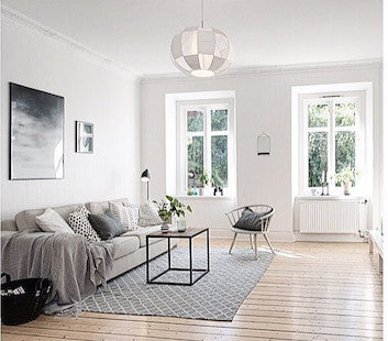 Light filled living room with soft grey contemporary sofa, with soft grey furnishings