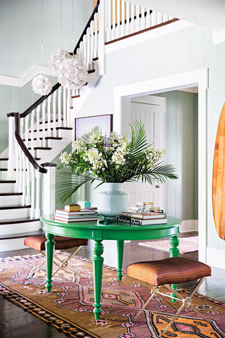 Foyer with staircase and green table