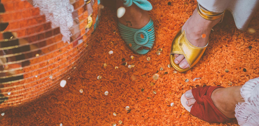 Colourful wedding shoes being showcased on an orange carpet