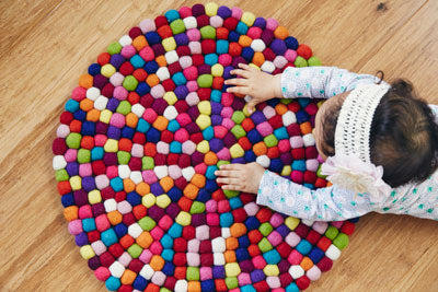 overhead shot of kid on rug