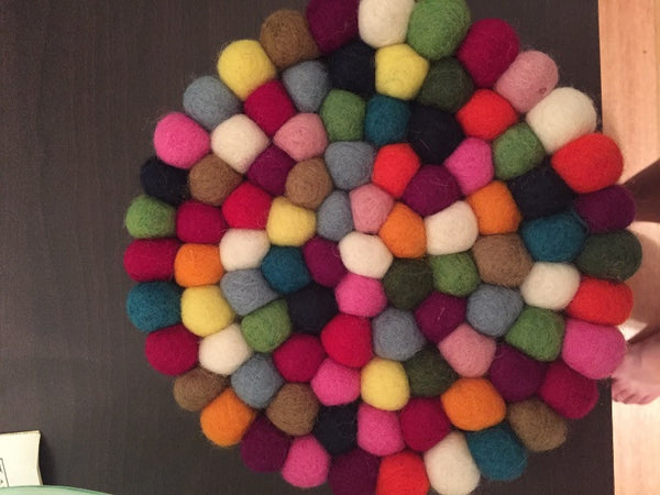 multicolored felt ball trivet