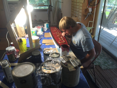 Seth painting a sign