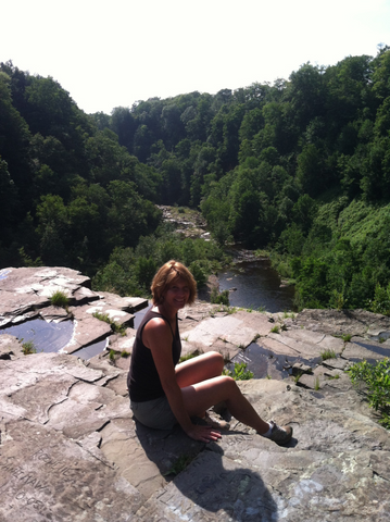 Ginny sitting on a rock