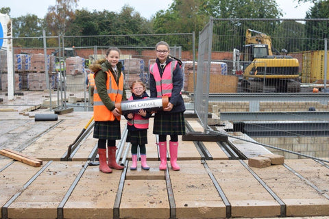 Time Capsules UK children burying time capsule underneath their new home