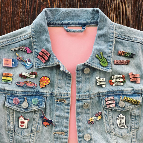 Colorful women's pin collection on denim jacket