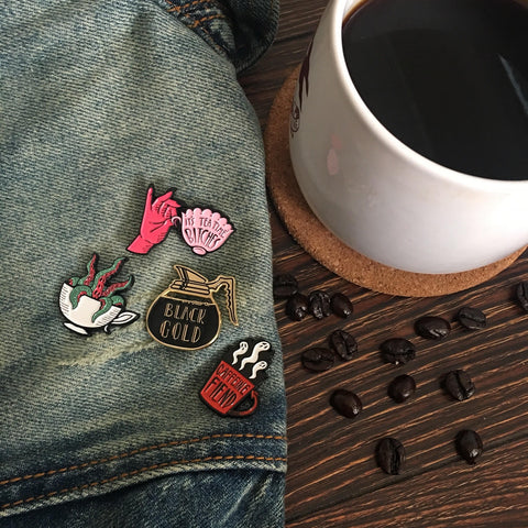Coffee and tea themed enamel pins.