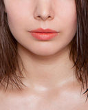 Herbivore Botanicals Coco Rose Lip Tint in Coral on lips