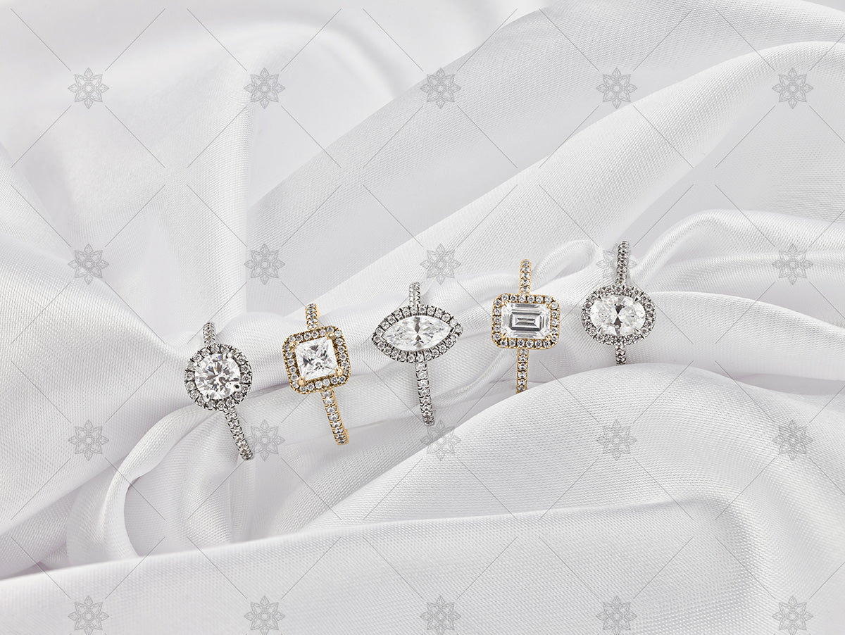 gold diamond cluster rings on white silk background