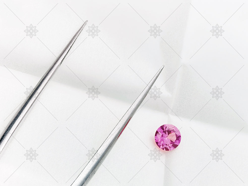 Pink sapphire and tongs