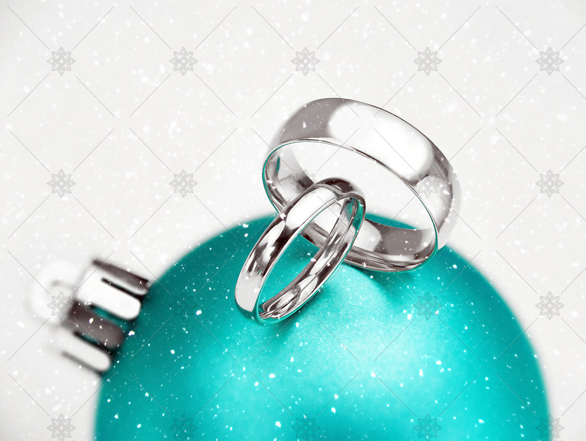 winter wedding rings on green bauble