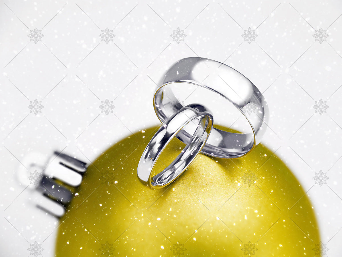 Winter wedding rings on yellow bauble