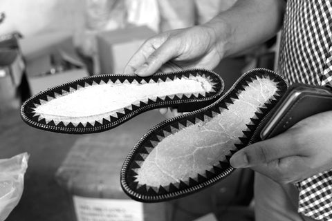 the sole of the shoe being inspected in Sri Lanka