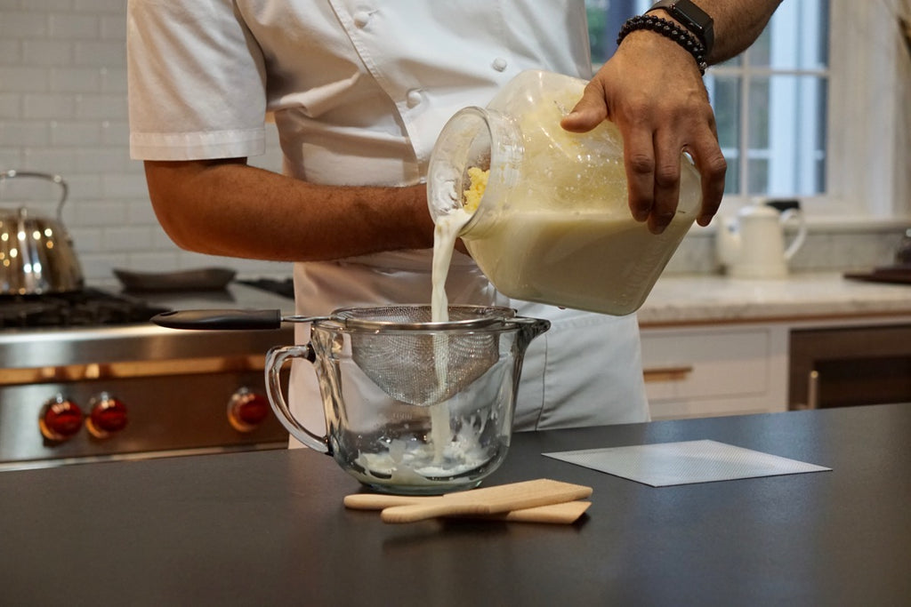 Pouring out buttermilk from Churncraft butter churn