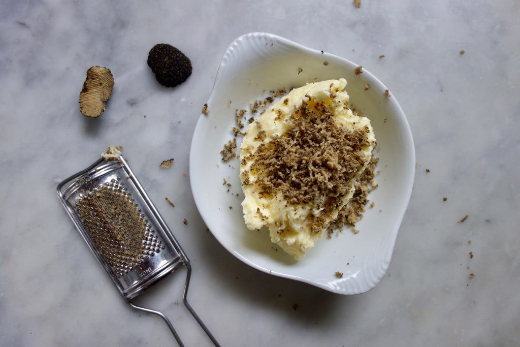 Black truffles next to truffle butter