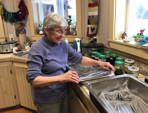 Ellie dyeing yarn in small batches.