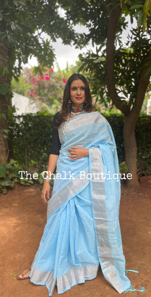 | Clear Blue | Blue linen saree with zari border and tasseled palla.