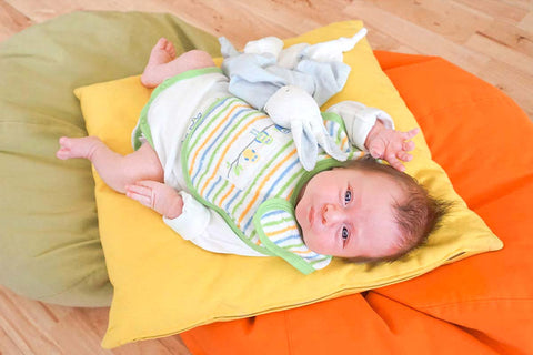 Fairtrade photoshoot with Baby Marcus modelling a fairtrade organic playsuit bib and bunny blanket