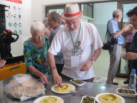 Fairtraders enjoying freshly prepared hummus in Fourzol - The Little Fair Trade Shop