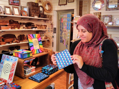 My sister Irem admiring a fairtrade mosaic dish at Shared Earth, York, UK