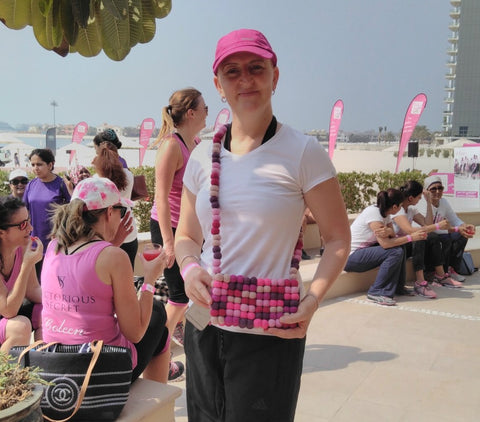 The inspirational Lisa organiser of the Pink Ladies Games and the Pink Caravan UAE modelling a totally bobbles pink fairtrade bag produced by fairtrade ladies at Friends Handicraft adn Maiti with the Lilfairtrade Shop