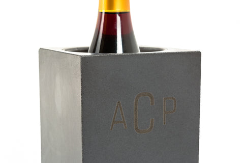A personalized concrete wine cooler, shaped like a brick with a hollowed out center that allows for regulated temperature.