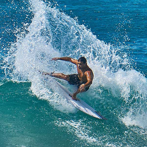 surfer slashing in stoked vision black boardshorts