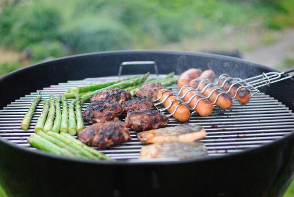 meat and vegetables on a round grill