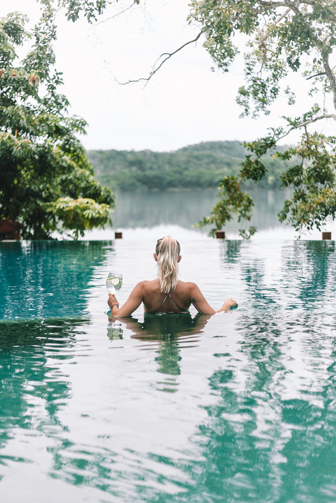 Alyssa enjoys view of the lagoon from pool at Las Lagunas Boutique Hotel, Boutique Hotels Guatemala, where to stay Tikal, best lodging in Tikal, coolest places to stay in Guatemala, ethical travel, boho resorts, boho hotels, hiptipico ethical travel