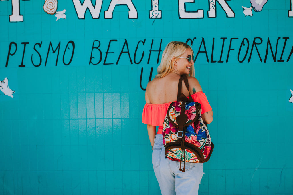 Alyssa wearing a ruffled pink swimsuit in Free People sunglasses and denim cutoffs