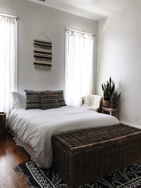 The bedroom is decorated in perfectly minimalistic, boho style