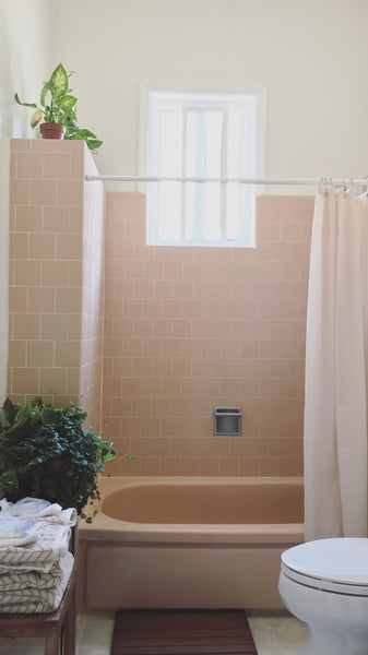 The bathroom is decorated in perfectly minimalistic, boho style