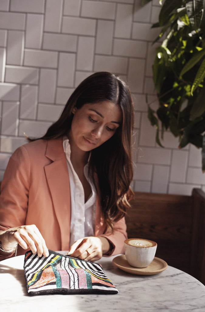 Style blogger @uniquelyyani styles Hiptipico in a daytime coffeeshop look for a style that can easily transition from day to night, ethically produced clutches, cute clutches for socially conscious consumers, best ethical clutches online