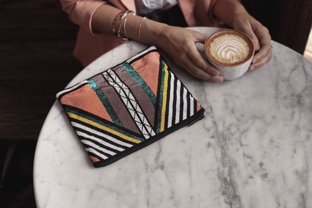 Style blogger @uniquelyyani styles a Hiptipico beaded clutch in a coffee shop for a daytime trendy look, beaded clutches, coolest clutches online, best ethical clutch picks