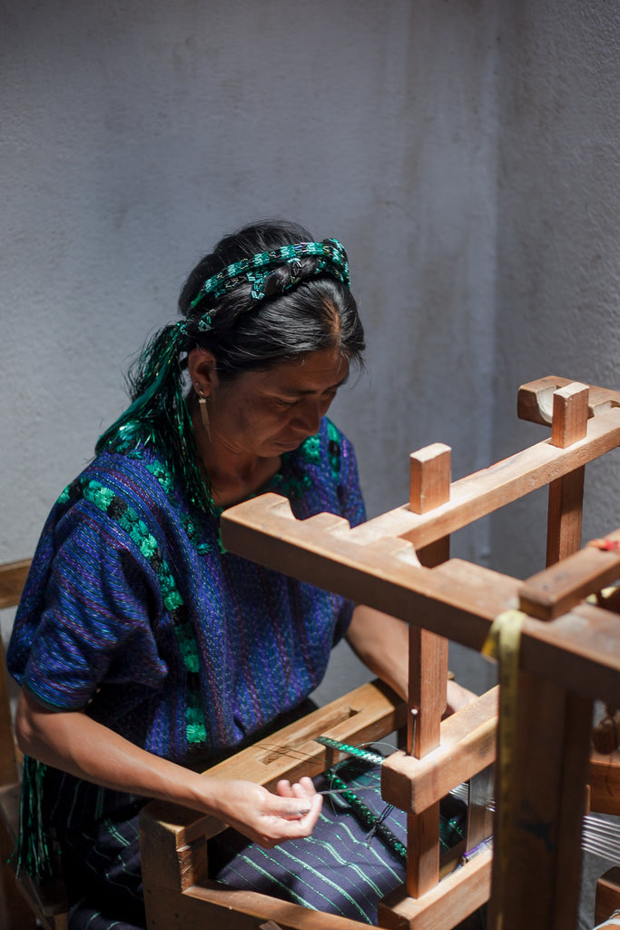 Maria works on the pedal loom to create a tocoyal, female artisan, foot pedal loom, cutting, stitching tooling