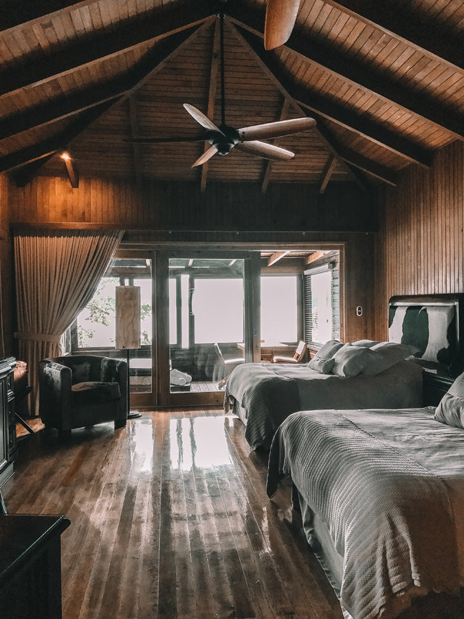 Room at Las Lagunas Boutique Hotel includes two large beds with wood floors deep brown furniture high steeply pitched ceiling and large balcony, luxe hotels Guatemala, luxe resorts Tikal, Tikal must see, must see guide Guatemala, Hiptipico ethical travel