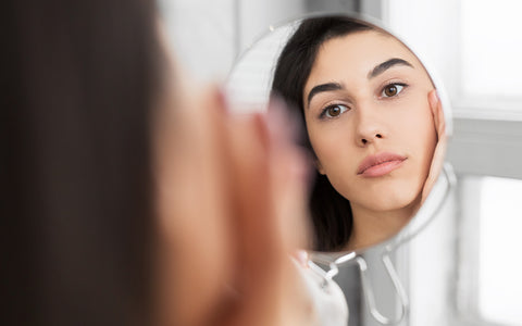 Woman Applying Skin Care Products