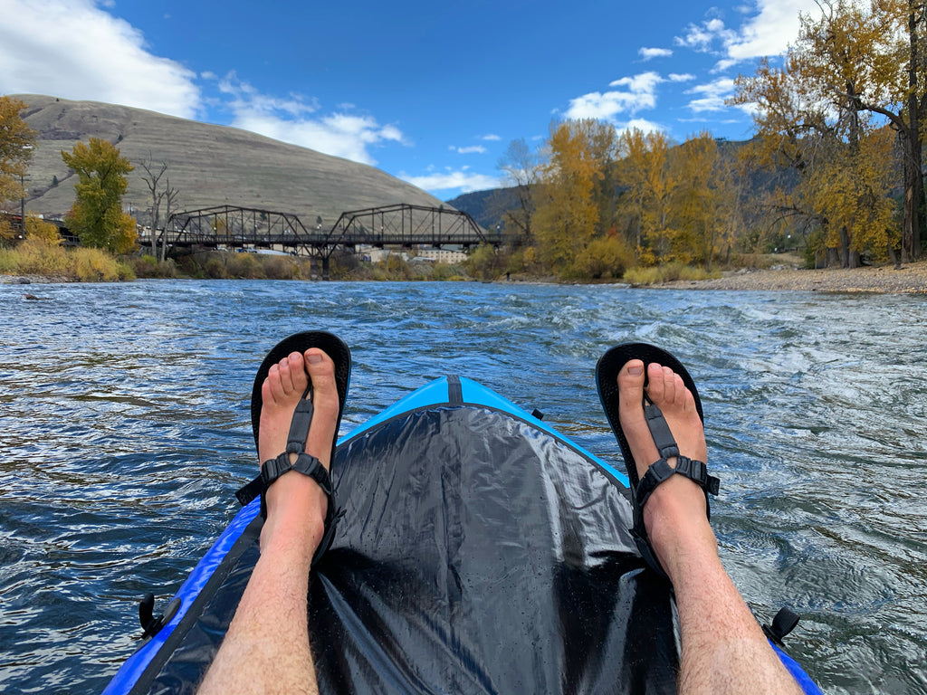 Packrafting through Missoula, Montana wearing adventure sandals