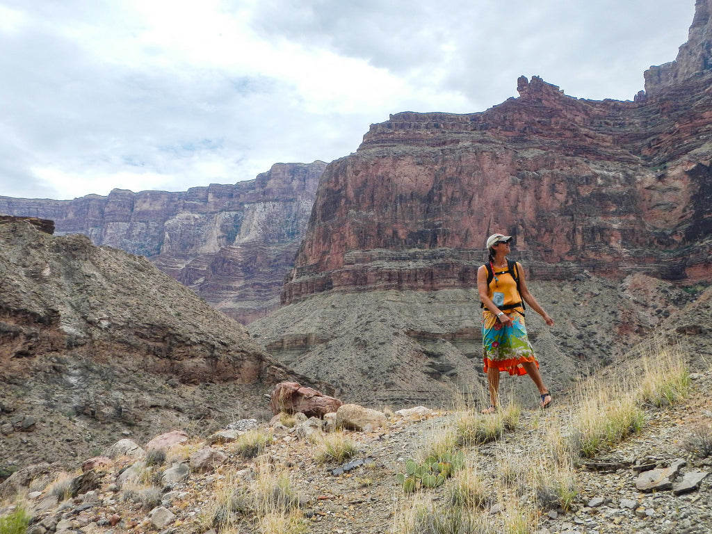 A whitewater raft guide hiking in Bedrock sandals and a dress