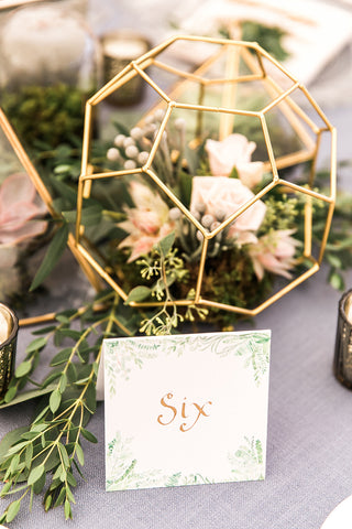 Table number with flourishing greenery in watercolor