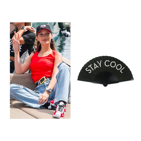 Bella Hadid at Grand Prix wearing relaxed jeans, sneakers and vest top. Khu Khu Stay Cool fan in image