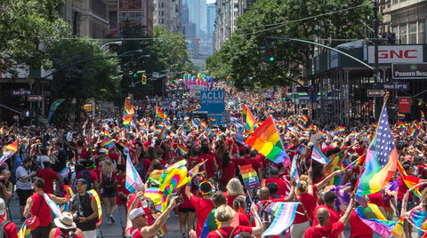 NEW YORK PRIDE. View up the main street with HUGE CROWDS and SEVERAL RAINBOW FLAGS