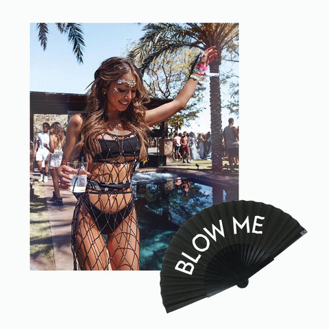 Instagrammer @germanbloggerinspo at Coachella 2019 wearing black skimpy bikini by swimming pool and a Khu Khu Blow Me hand fan