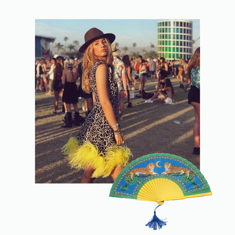 photo of instagrammer Sukilov at Coachella 2019  wearing leopard dress with yellow frill and Khu Khu lazy leopard hand fan 