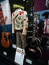 Gram Parsons Nudie Cohn Suit in Museum surrounded by his guitars