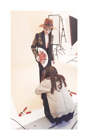 Leonora being styled on set by Barbara for the Khu Khu Hand-Fan Wild is the Wind Photoshoot at Wolf and Badger Studios, East London