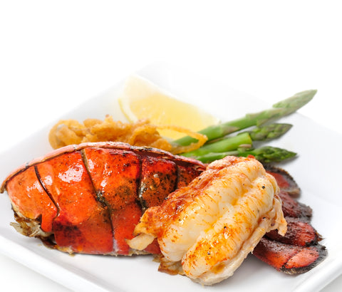 Lobster tail and vegetables on a white plate